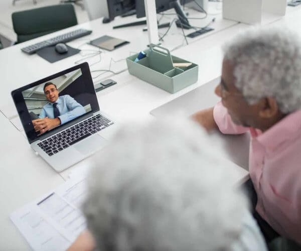 Two people on a video call receiving expert insurance guidance and support.